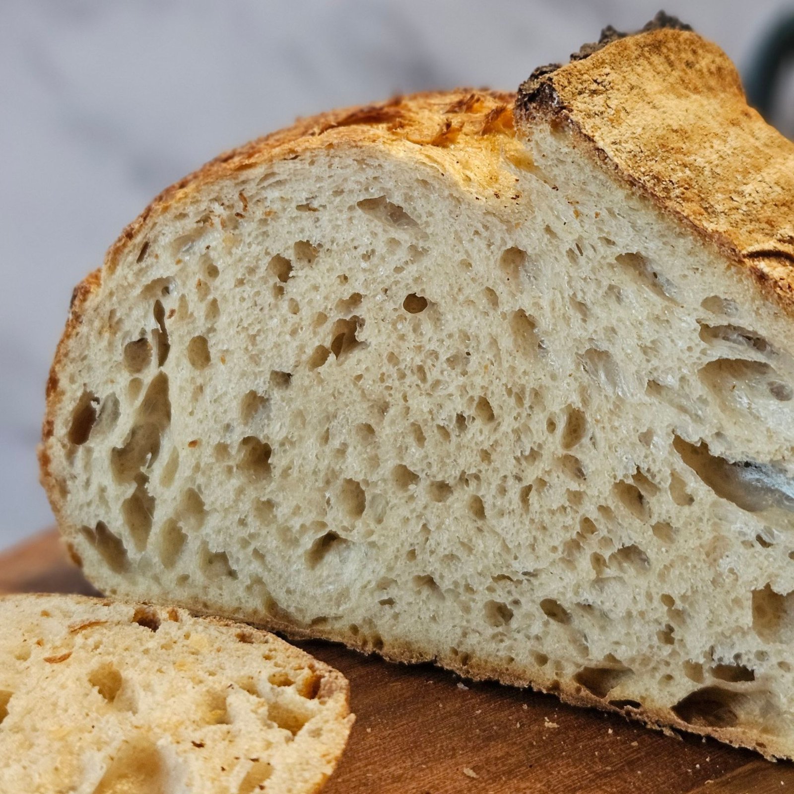 A cut open loaf showing a tender, aerated crumb.